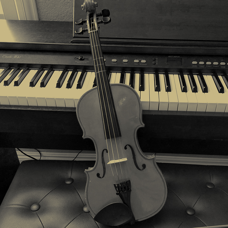Photo of a violin and digital piano