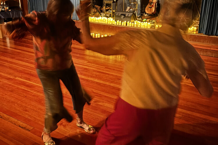 Dancers in front of stage of guitar duet