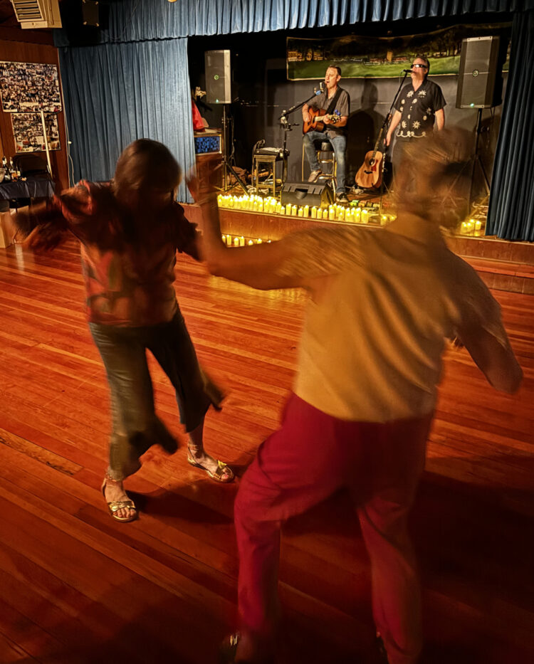 Dancers in front of stage of guitar duet